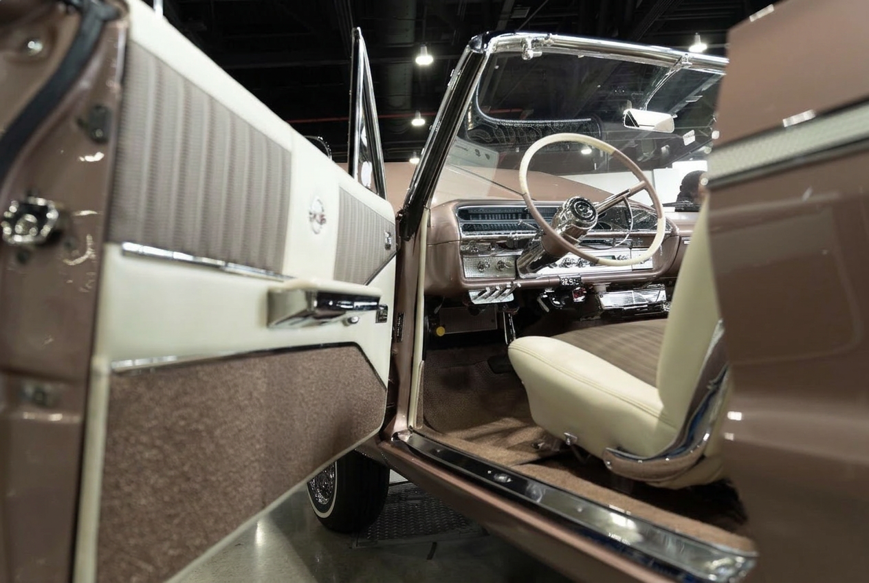Cream and tweed custom interior of a rose gold Impala convertible with the door open at a car show